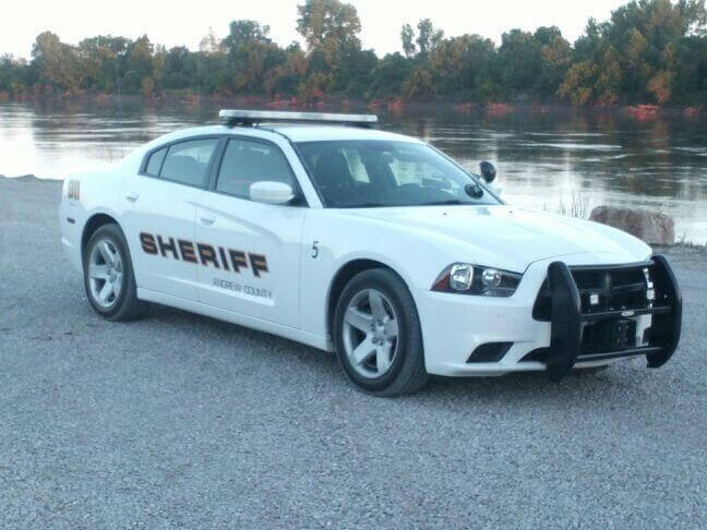 A Sheriff's vehicle parked by the lake.